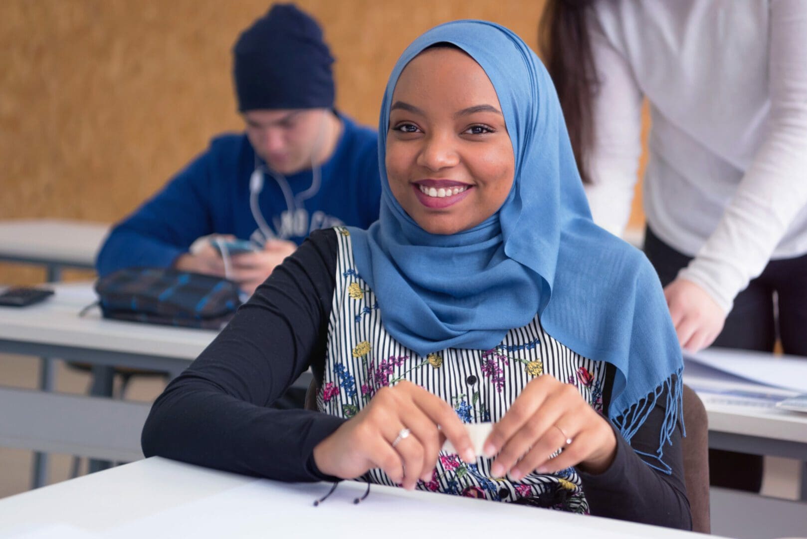 Beautiful female muslim african american architecture student looking and smiling into camera.