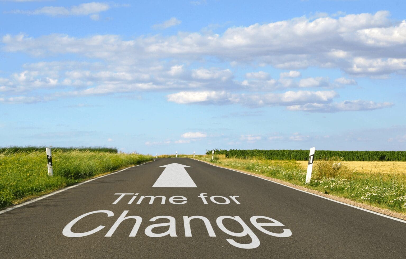 A road with the phrase “Time for Change”