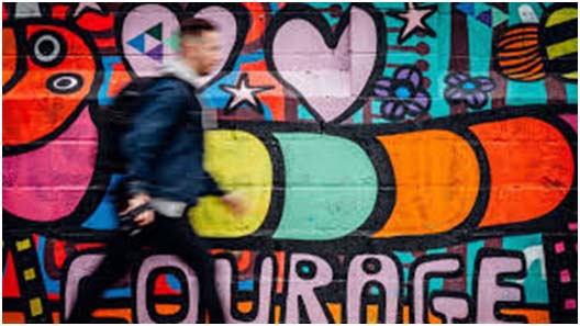 Man walking past colorful wall