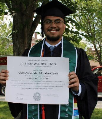 Graduation day with a proud smile holding a diploma.